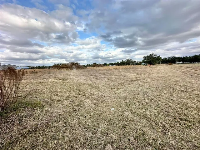 a view of a patio with table and chairs and potted plants