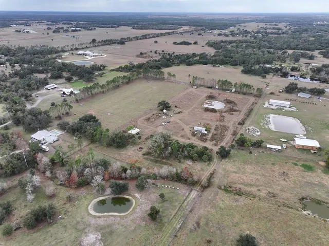 an aerial view of a house with a lake view