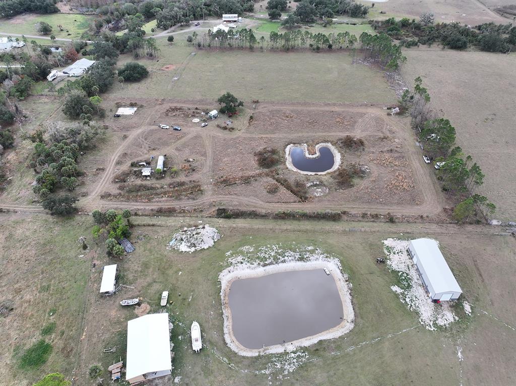 14780 Sugarbowl Road Myakka City, FL 34251 - Photo 28 of 53 an aerial view of a house with outdoor space and lake view