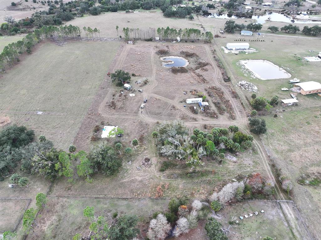 14780 Sugarbowl Road Myakka City, FL 34251 - Photo 34 of 53 an aerial view of a house with a yard and trees