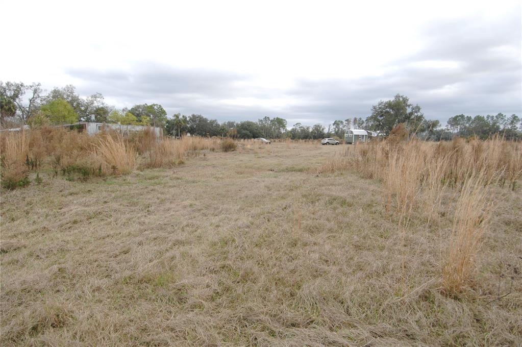 14780 Sugarbowl Road Myakka City, FL 34251 - Photo 44 of 53 a view of a lake with houses in the back