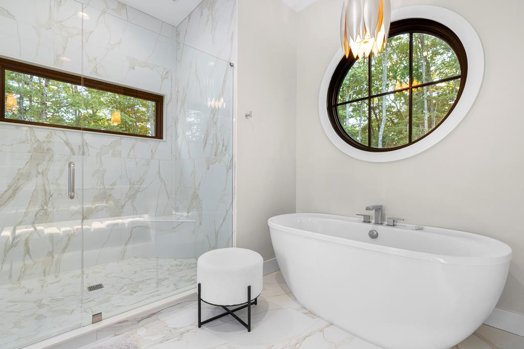 417 Bill Claypool Drive Blue Ridge, GA 30513 - Photo 29 of 73 a white bath tub sitting next to a white sink and a vanity