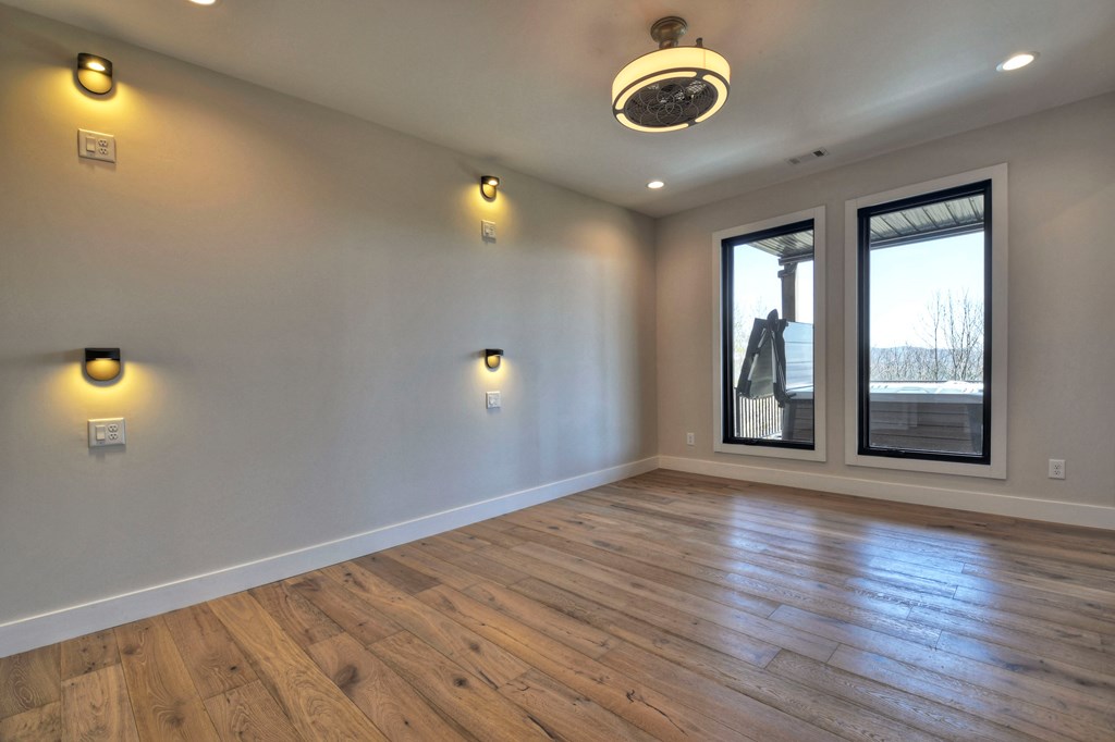 417 Bill Claypool Drive Blue Ridge, GA 30513 - Photo 49 of 73 an empty room with wooden floor and windows