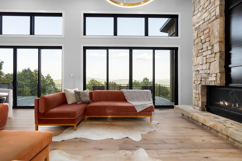 417 Bill Claypool Drive Blue Ridge, GA 30513 - Photo 8 of 73 a living room with furniture and a floor to ceiling window