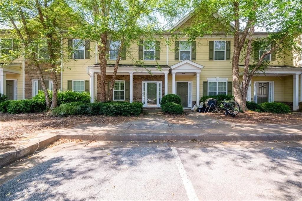 585 McWilliams Road Southeast, Unit 2303 Atlanta, GA 30315 - Photo 1 of 1 a front view of a house with garden and trees