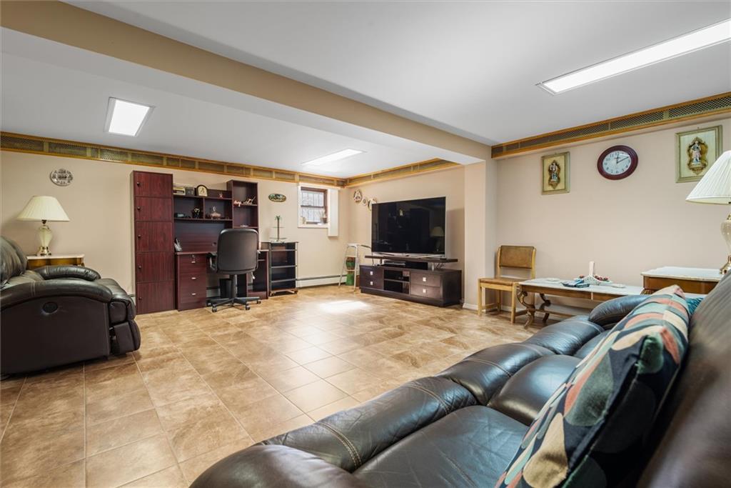 159 Hastings Street Brooklyn, NY 11235 - Photo 17 of 32 a living room with furniture and a flat screen tv