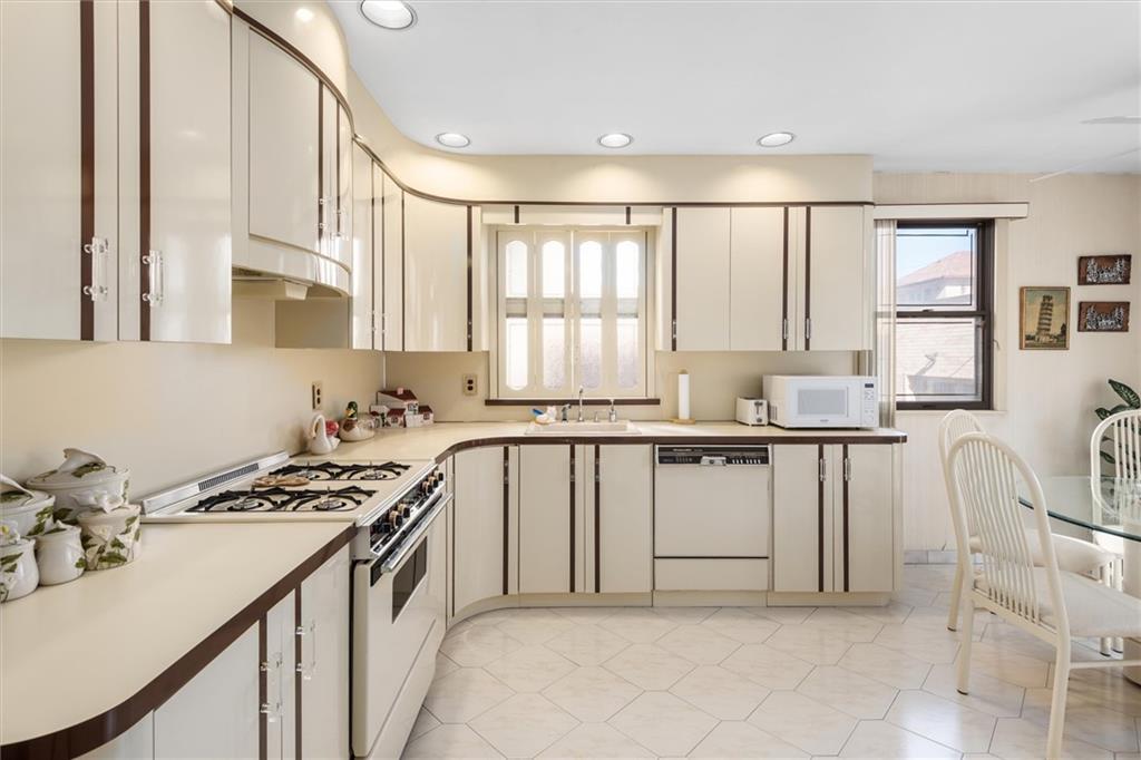 159 Hastings Street Brooklyn, NY 11235 - Photo 7 of 32 a kitchen with stainless steel appliances a white cabinets and a stove top oven