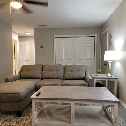 a living room with furniture and a lamp
