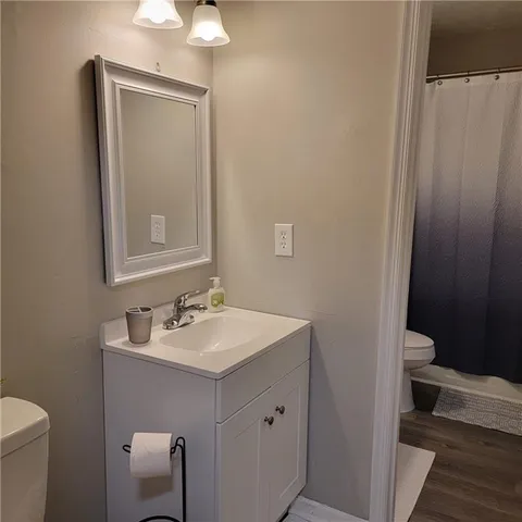 a bathroom with a sink toilet and a mirror