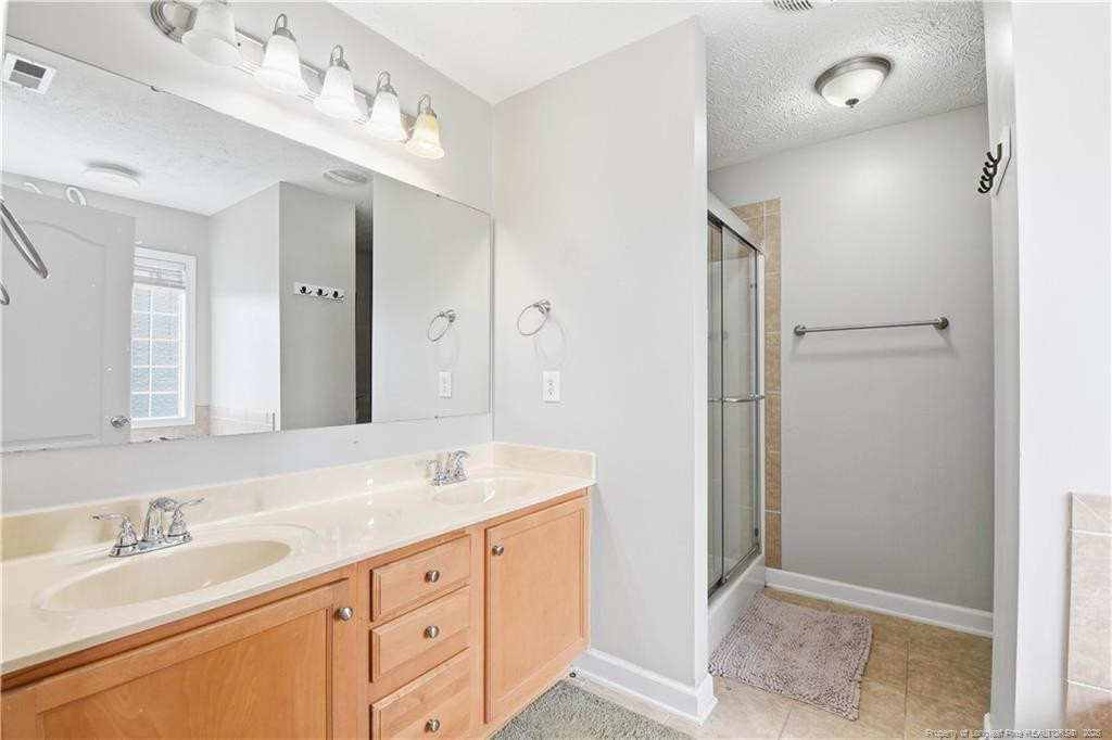 212 Lennox Loop Raeford, NC 28376 - Photo 29 of 47 a spacious bathroom with a double vanity sink mirror and double