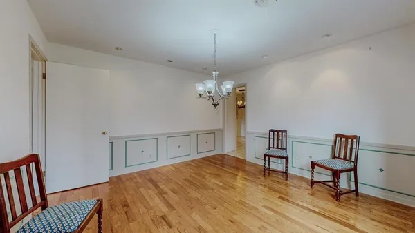 a bedroom with furniture and a chandelier