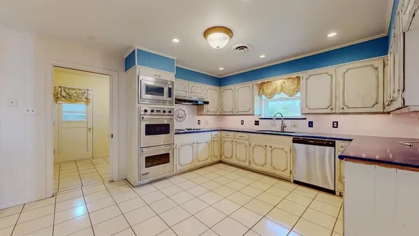 a kitchen with stainless steel appliances granite countertop a refrigerator sink and cabinets