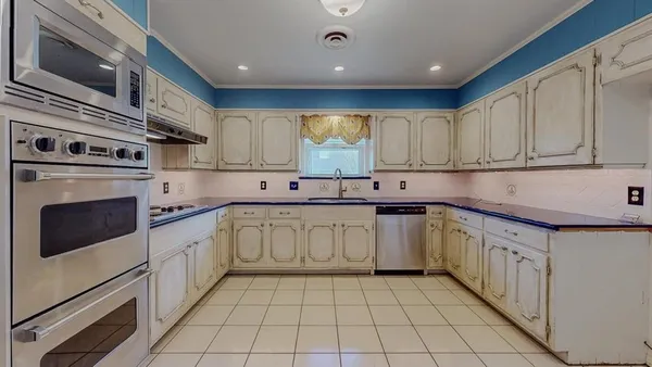 a kitchen with stainless steel appliances granite countertop a sink and cabinets