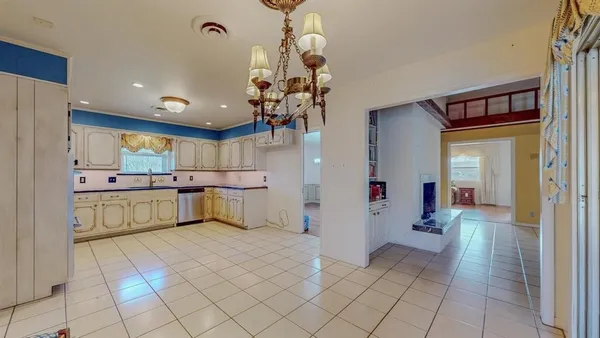 a kitchen with a refrigerator and a sink