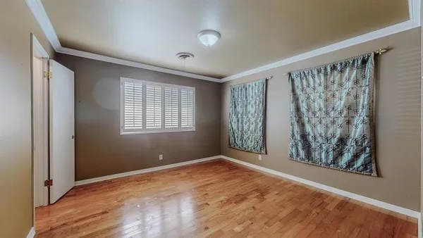 a view of a kitchen with furniture cabinets and wooden floor