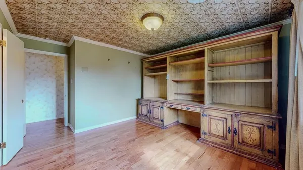 a view of gallery with wooden floor