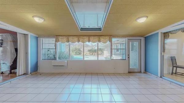 a view of a porch with furniture and floor to ceiling window