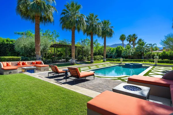 a view of a house with backyard porch and sitting area
