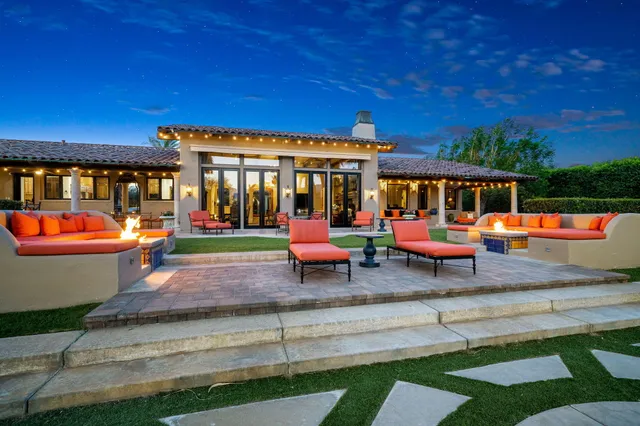 a bathroom with a granite countertop sink mirror vanity and toilet