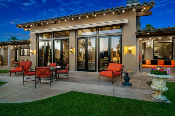 a view of a house with backyard porch and sitting area