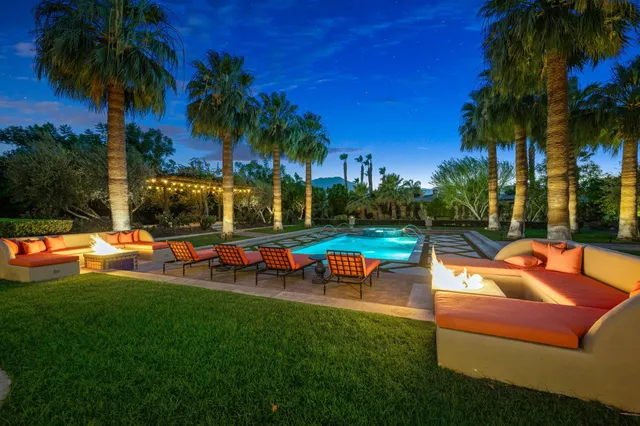 a view of a house with swimming pool and a yard