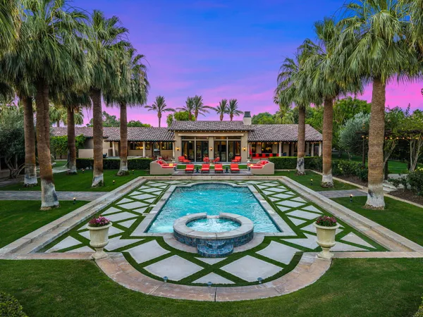 a bathroom with a granite countertop sink a mirror and a shower