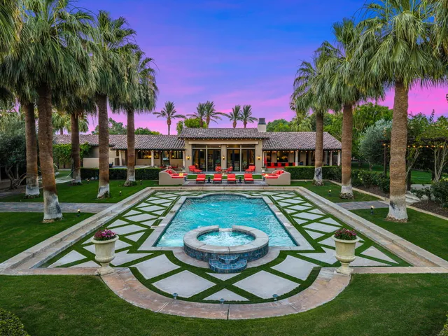 a bathroom with a granite countertop sink a mirror and a shower