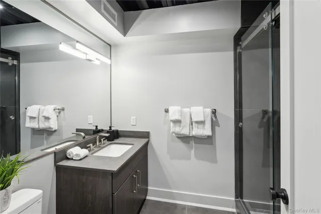 a bathroom with a sink vanity and mirror