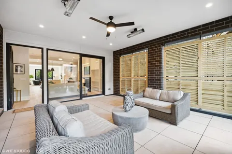 a living room with furniture and floor to ceiling windows