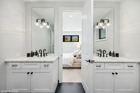 a bathroom with a sink vanity and mirror
