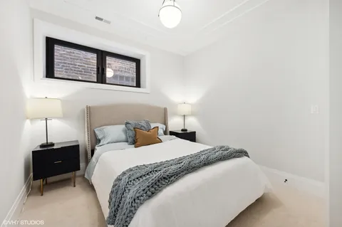 a bedroom with a bed and a lamp