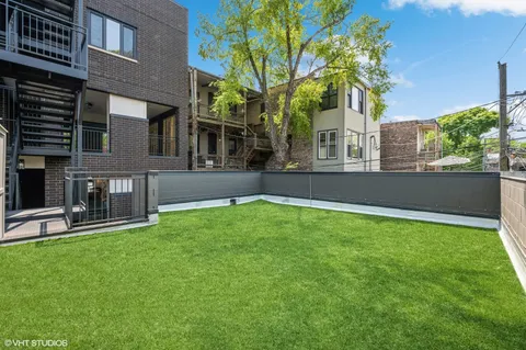a view of a house with a yard and a tree