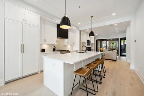 a kitchen with a sink and chairs
