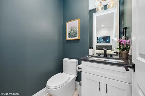 a bathroom with a toilet a sink and a mirror