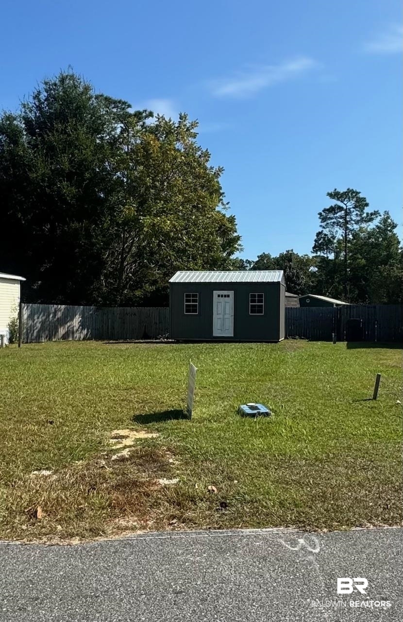 672 Escambia Loop Lillian, AL 36549 - Photo 2 of 24 View of yard featuring an outdoor structure
