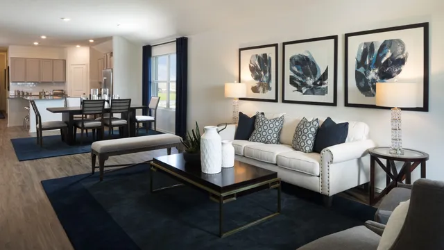 a living room with furniture and kitchen view