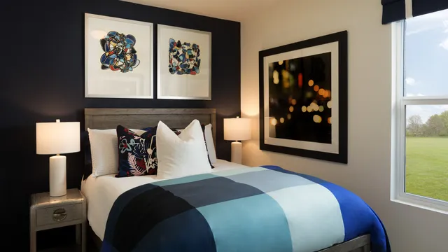 a bedroom with bed and wall painting