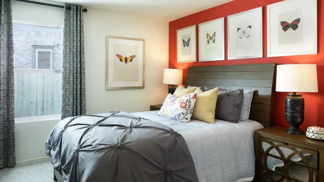 a bed sitting in a bedroom next to a window