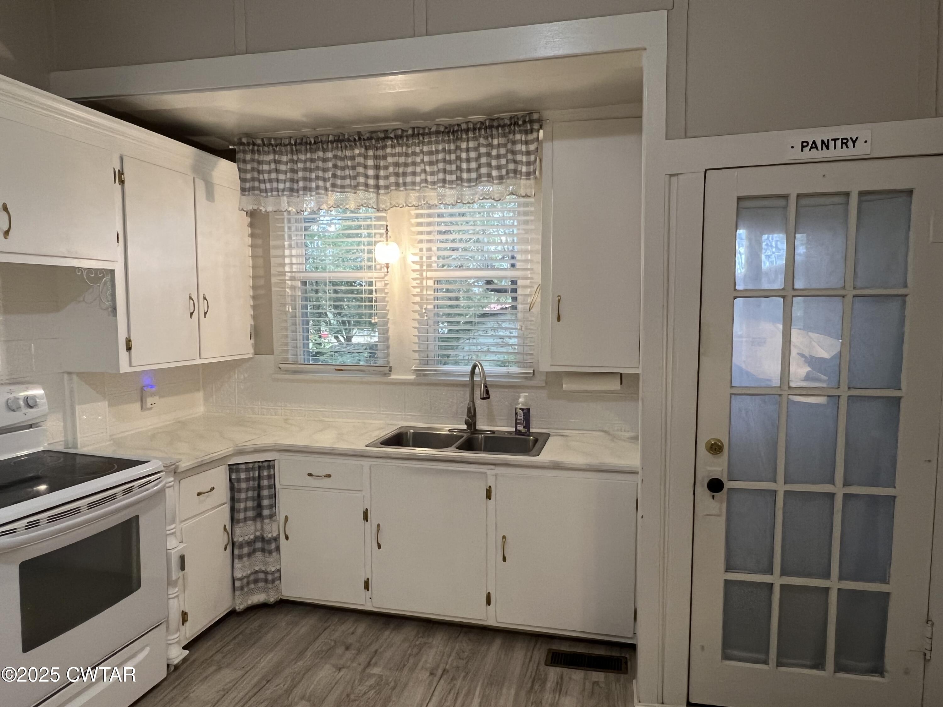 117 South Main Street Gibson, TN 38343 - Photo 16 of 40 a kitchen with a sink stove and cabinets