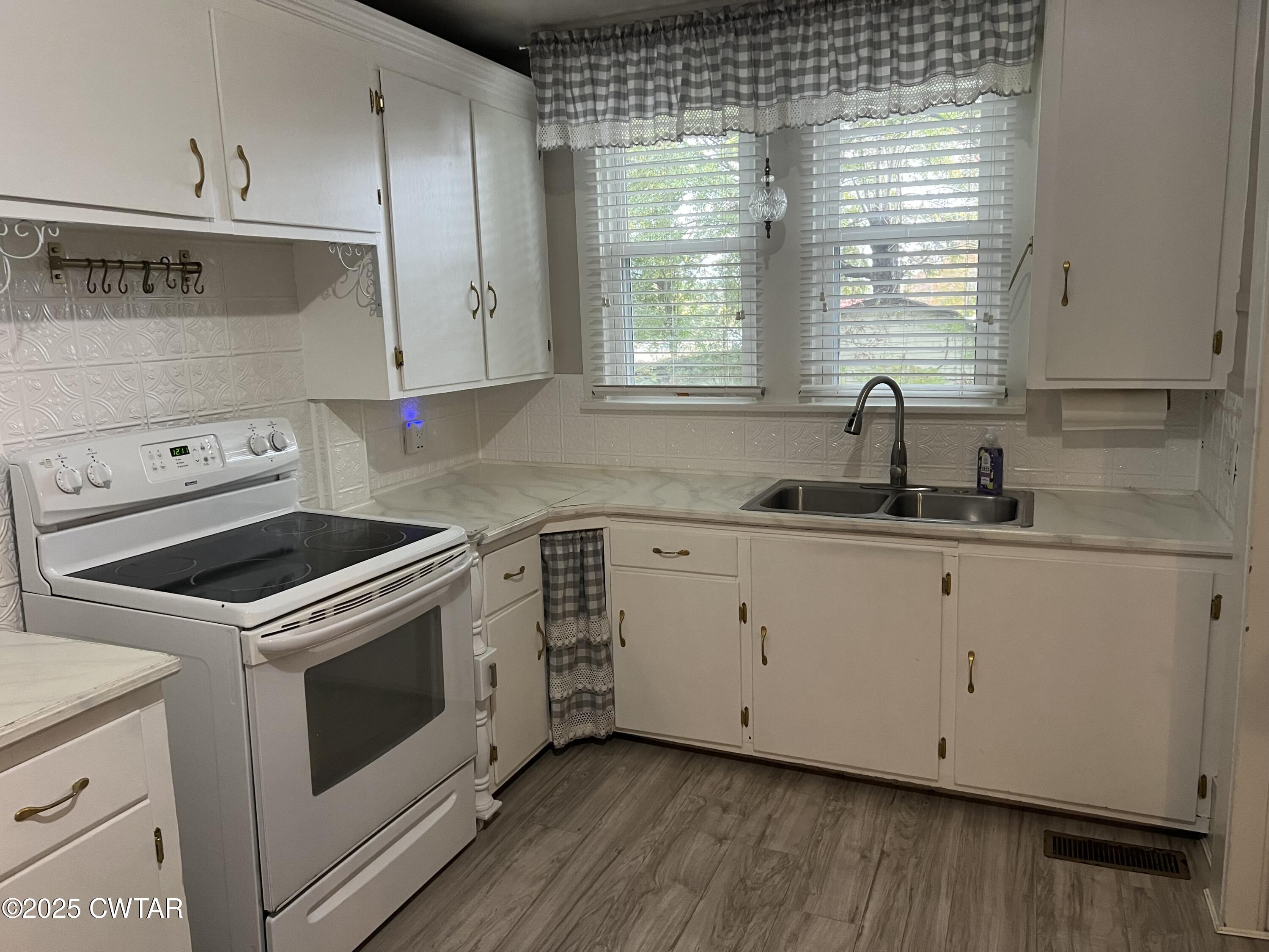 117 South Main Street Gibson, TN 38343 - Photo 17 of 40 a kitchen with granite countertop white cabinets and white appliances