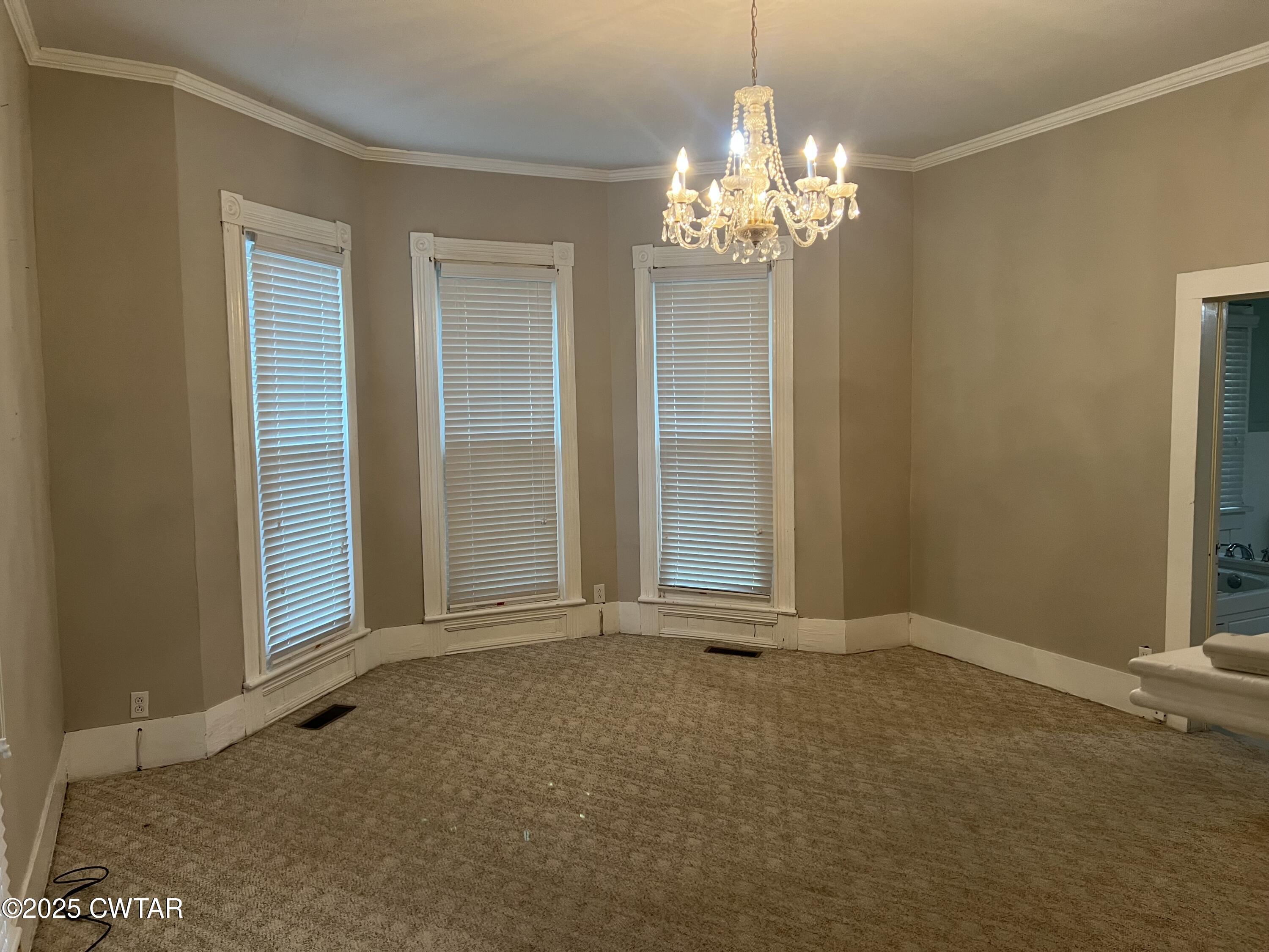 117 South Main Street Gibson, TN 38343 - Photo 21 of 40 a view of an empty room with a chandelier