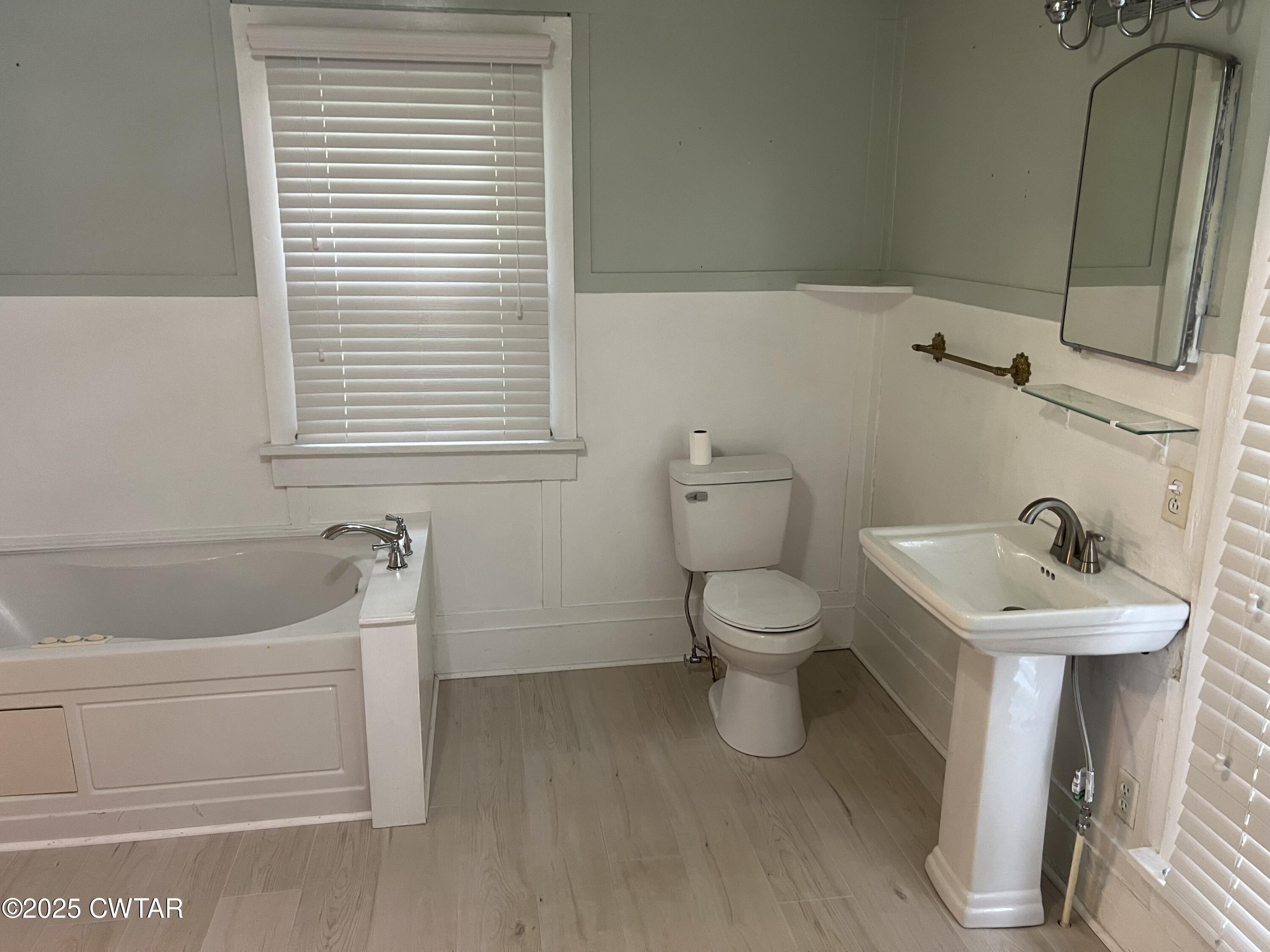 117 South Main Street Gibson, TN 38343 - Photo 34 of 40 a bathroom with a sink a toilet and a bathtub