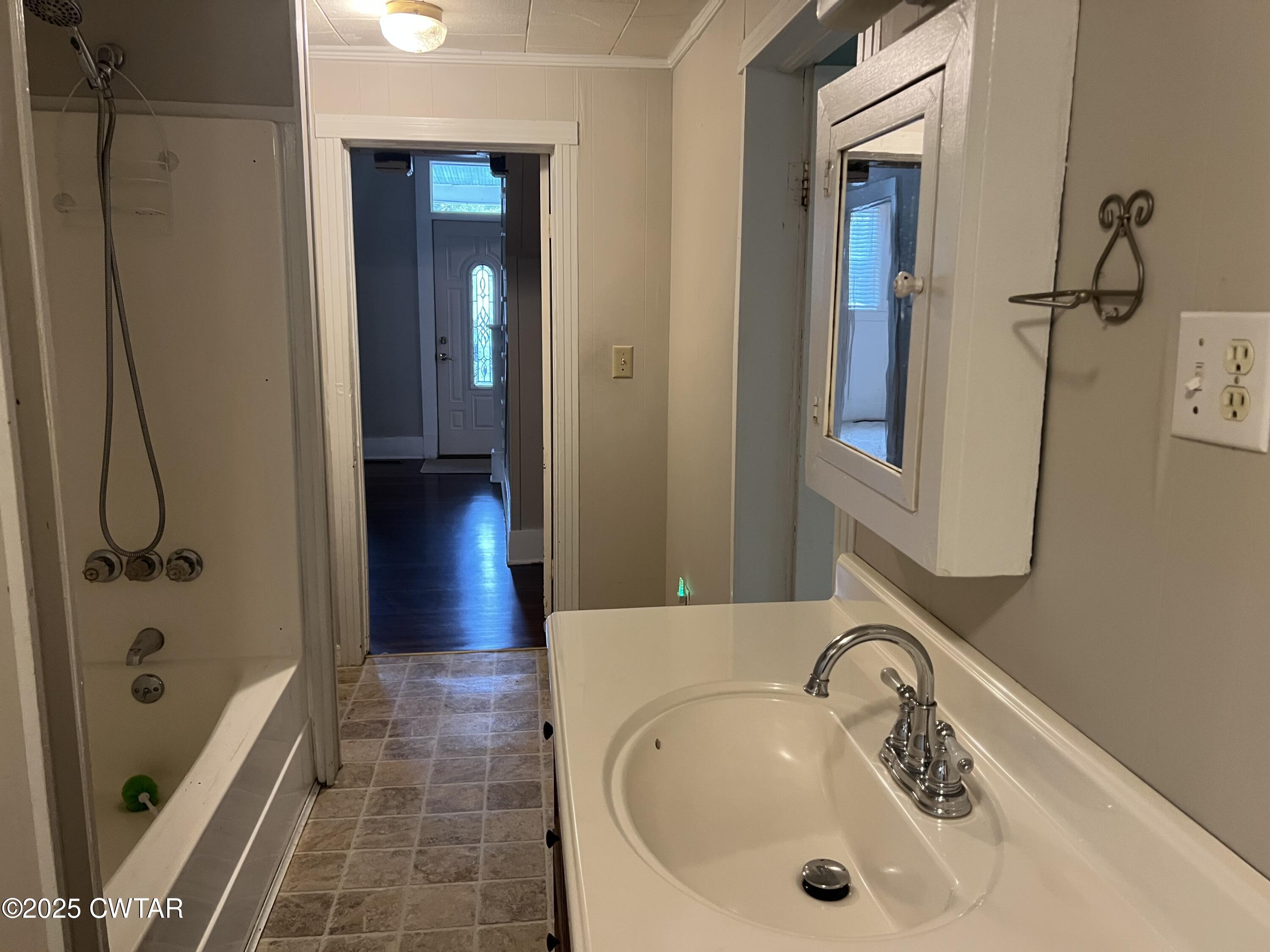 117 South Main Street Gibson, TN 38343 - Photo 38 of 40 a bathroom with a sink and a tub