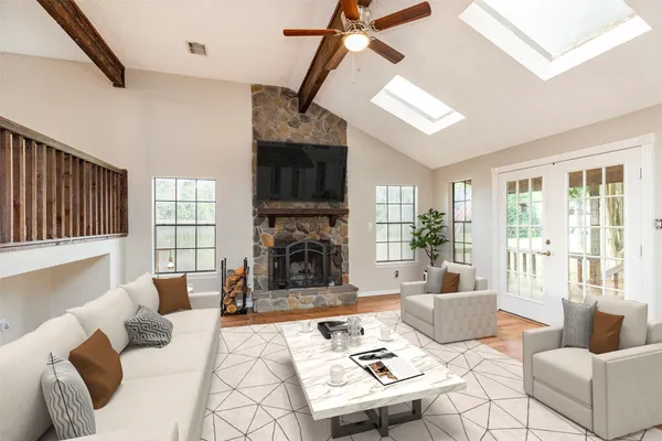 a living room with furniture a fireplace and a flat screen tv