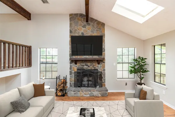 a living room with furniture a window and a fireplace
