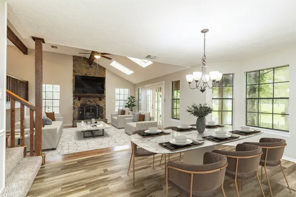 a living room with fireplace furniture and a chandelier