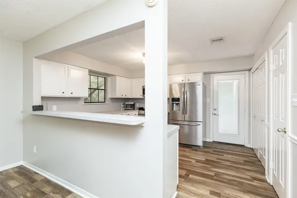 a kitchen with stainless steel appliances refrigerator and cabinets