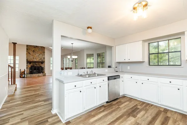 a kitchen with a sink cabinets and window