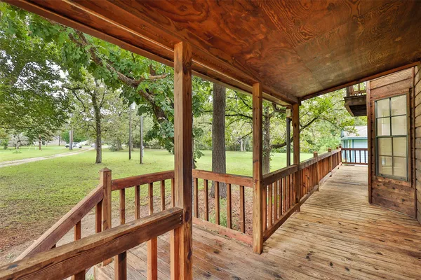 a view of a porch with wooden floor and outdoor space