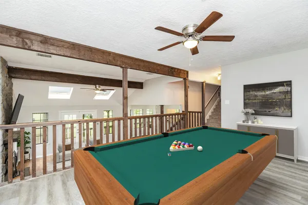 a view of a livingroom with hardwood floor and a ceiling fan